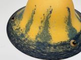 a yellow and blue hat on a white table