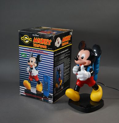 mickey mouse figurine with box on grey background