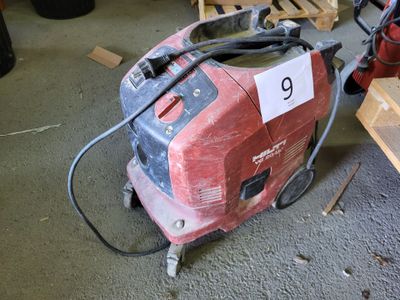 a red and black machine that is sitting on the floor