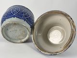 two blue and white vases sitting next to each other