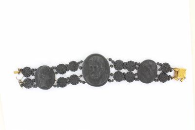 un gros plan d'un bracelet orné d'une pièce de monnaie