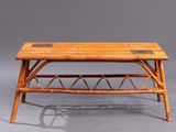 a bamboo coffee table with a glass top and a wooden frame