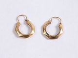 a pair of gold hoop earrings on a white background