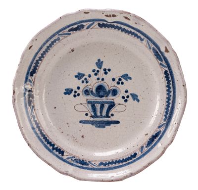 a blue and white plate with a flower design on it