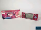 a pink game console and a pink box on a white surface