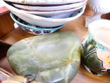 many bowls and cups sitting on a table together