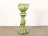 a green vase that is sitting on a table