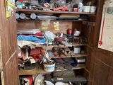 a wooden cabinet filled with lots of tools in a room