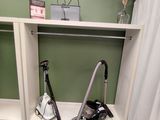 a vacuum that is sitting on the floor in the bathroom