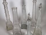 five glass vases that are sitting on a table