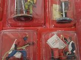 six small plastic figurines of soldiers in red boxes