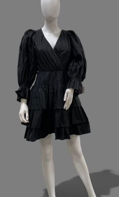 a mannequin wearing a black dress with ruffles on it