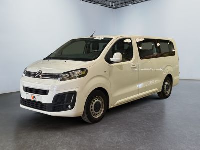 the white van is parked in a white room with a black floor