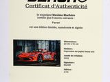a white book with a picture of a red sports car on it