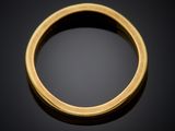 a close up of a gold ring on a black surface