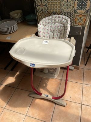 a baby high chair that is sitting in the kitchen