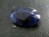 a close up of a blue sapphire stone on a black surface