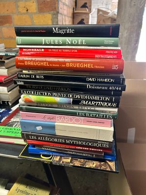 many books stacked on top of each other on a table
