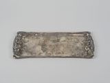 a silver plate with a flower design on it