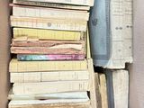 a box full of books that are stacked on top of each other