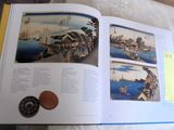 a book with a picture of a city and a coin