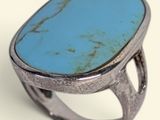 an oval turquoise stone ring set in a silver setting