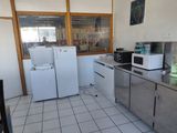 a kitchen with a refrigerator, microwave, and a refrigerator freezer