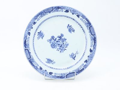 a blue and white plate with a floral design on it