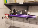 a purple tube on a shelf in a bathroom