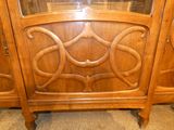 a wooden cabinet that has a glass door on top of it