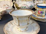 a lot of tea cups and saucers sitting on a table