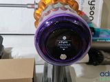 a close up of a purple vacuum cleaner on a desk