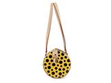 a yellow and black polka dot purse on a white background