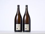 two bottles of wine sitting next to each other on a table