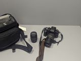 a camera, a camera bag, and a camera on a table