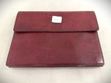 an image of a red leather wallet with a white tag on it