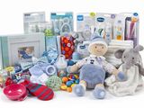 a pile of baby items that include a stuffed elephant, pacifier, bottle, rattler, rattler, rattler, rattler, rattler