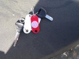 a keychain with a red heart on it sitting on a seat