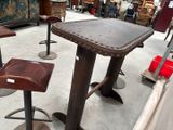 tables and stools in a room with a lot of furniture in the background