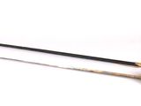 two swords that are sitting on a white surface