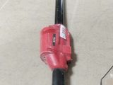a red and black blower sitting on the floor in a garage