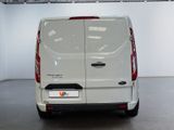 the rear of a white van is parked in a garage
