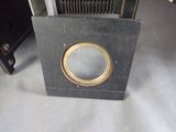 a small black box with a gold ring on top of it