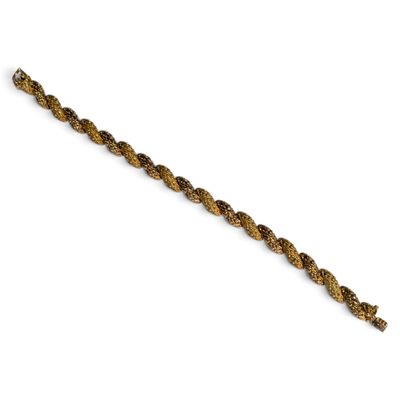 a close up of a gold bracelet on a white background