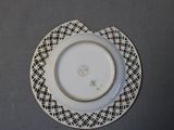 a white plate with a flower on it on a table