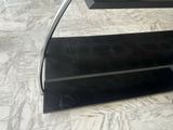 a black glass staircase with a metal handrail on top of it