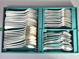 a lot of spoons and forks in a green box