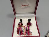 two pairs of earrings in a red box on a table