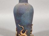 un vase bleu orné d'un dragon doré