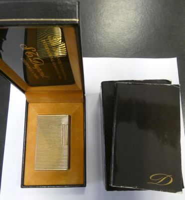 a box with a lighter and a wallet on a table